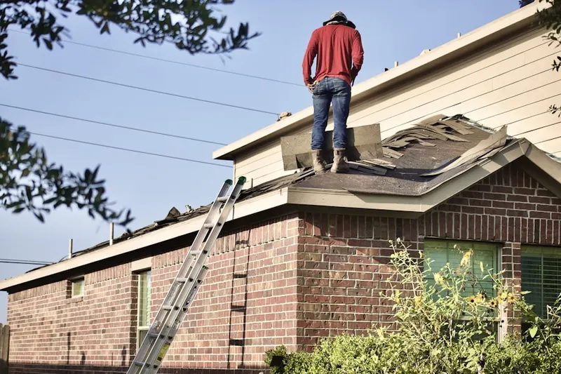 Professional roofer working on a residential roof in Marble Dale